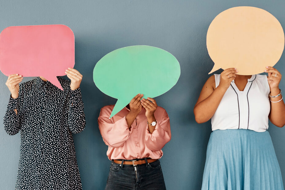 photo of women holding paper speech balloons to represent communication quotes